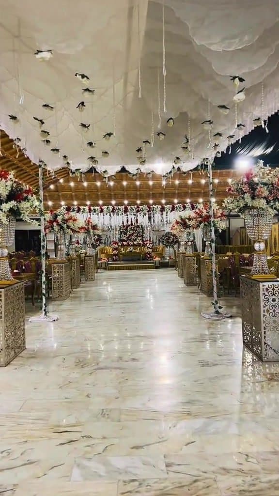Hall decorated with a draped fabric ceiling and floral stands