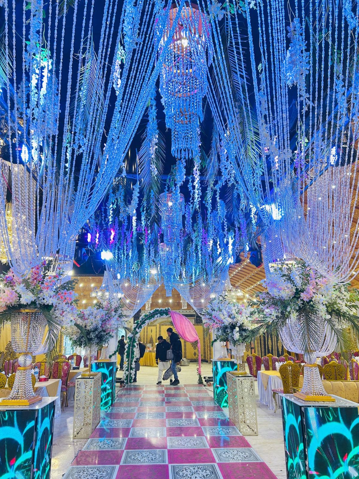 Crystal chandeliers and illuminated hall décor inside Sadiq Pearl Marquee