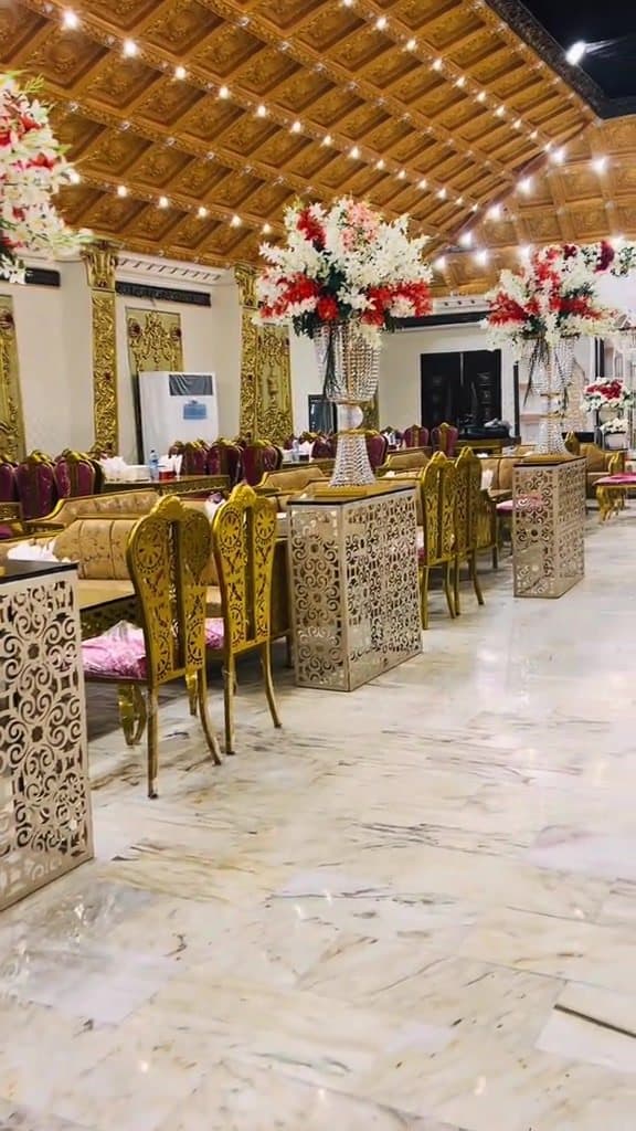 Banquet Seating — Guest tables and chairs arranged across the marble hall floor.
